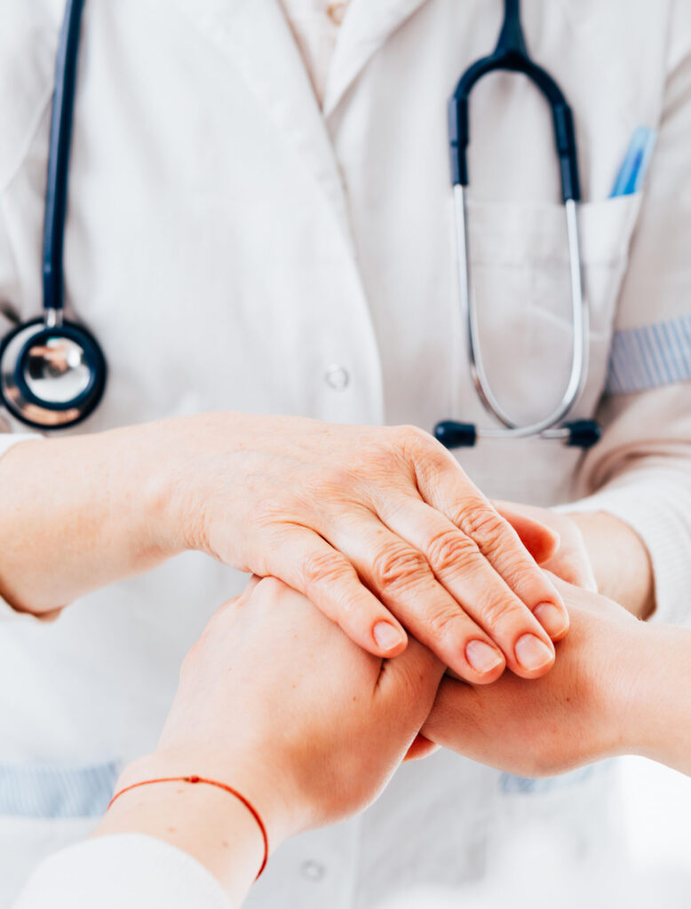 Doctor holding patient hands